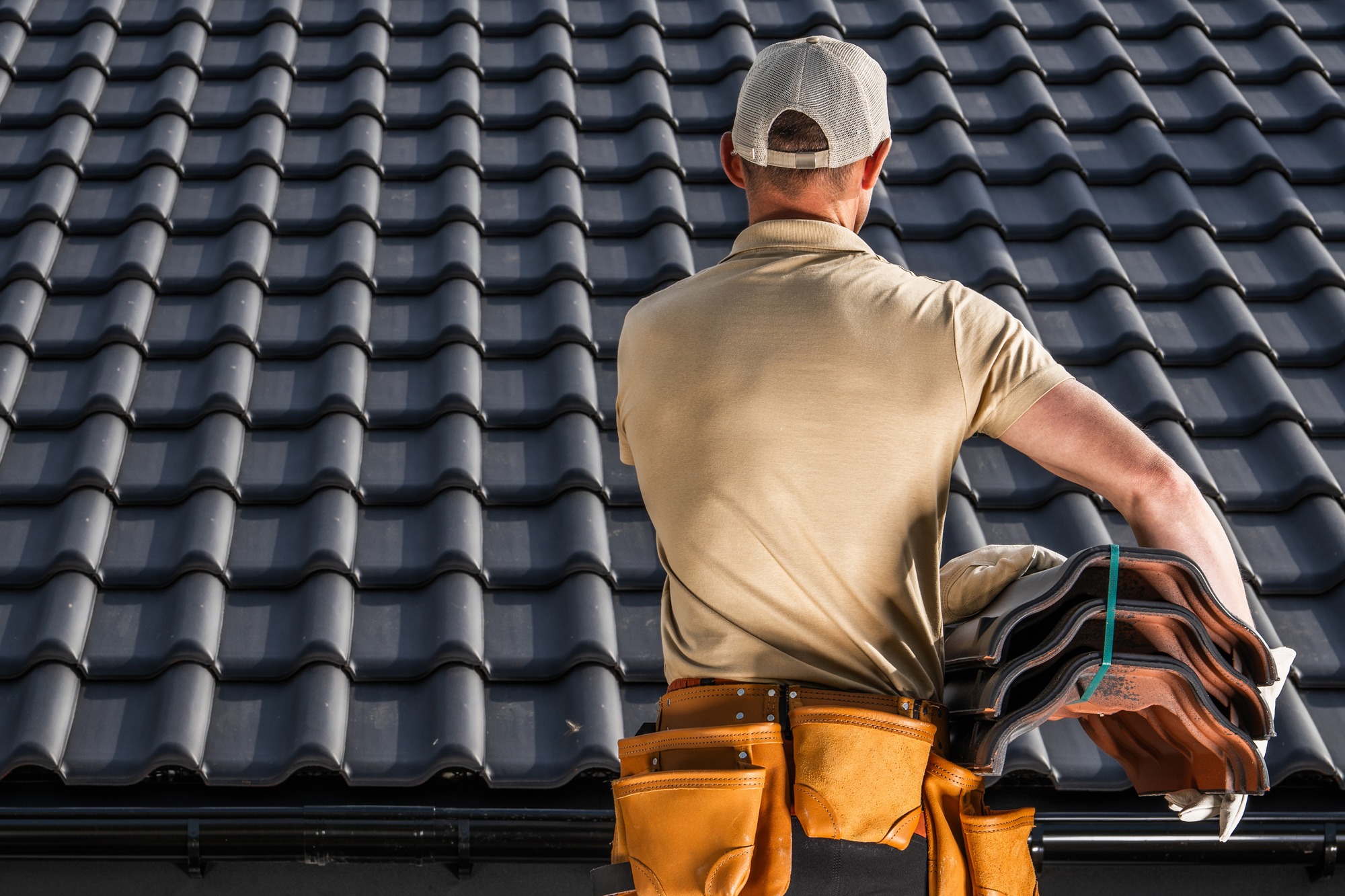 Roofer assessing tiled roof